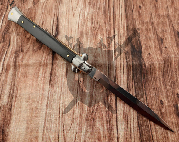 Reverse side of Frank Beltrame Italian automatic knife featuring dark buffalo horn scales and polished bayonet blade