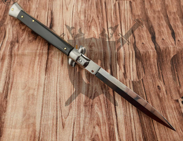 Reverse side of Frank Beltrame Italian automatic knife featuring dark buffalo horn scales and polished spear point blade