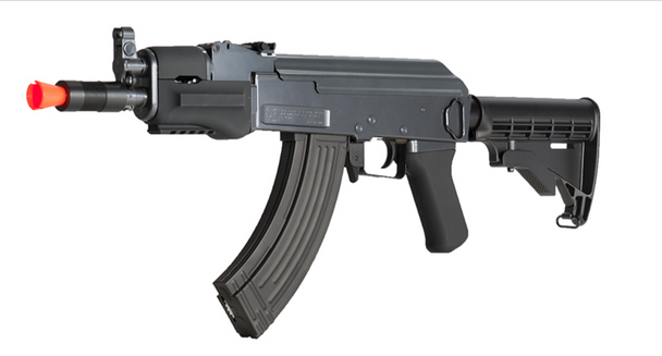 Left-side studio image of Double Eagle M901B AK-style airsoft rifle with orange safety tip, black polymer adjustable LE stock, and 600-round curved hi-cap magazine.