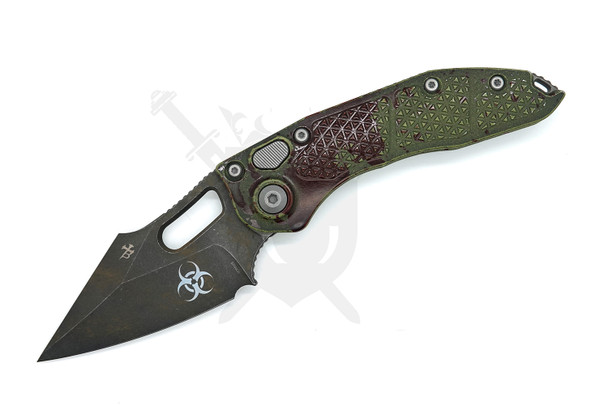 Microtech Borka Stitch 169-1OBS open – front view showing spear point M390 blade and Outbreak deep-engraved handle with biohazard logo.