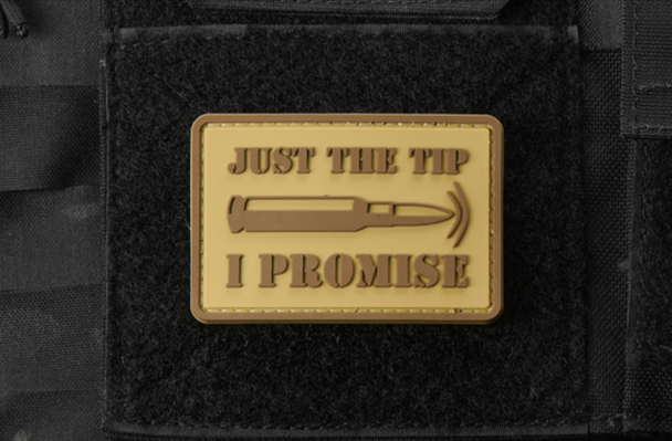 Coyote tan PVC morale patch reading “Just the Tip, I Promise” with a raised bullet graphic mounted on a tactical vest.