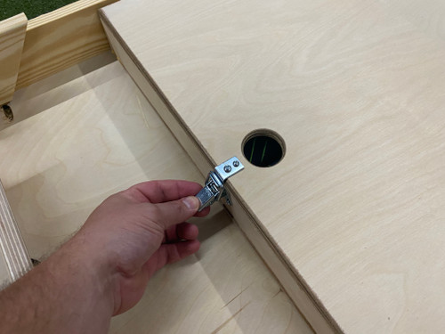 Underside of a high quality cornhole board with built in bag storage latching mechanism.