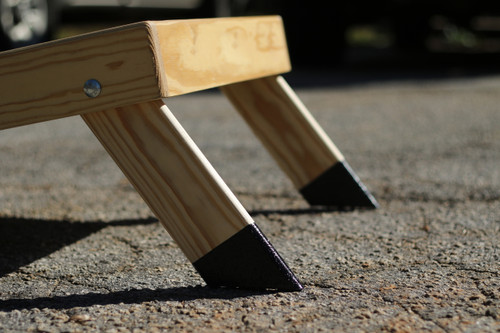 A close-up view of cornhole board leg protectors. The durable design helps prevent damage, and improve grip, ensuring long-lasting use for Economy and Standard Build boards. Ideal for both recreational and tournament play.