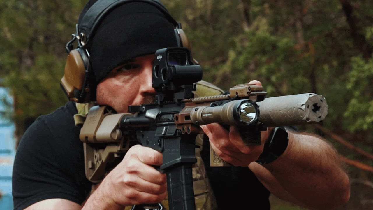Short-barrel gas gun under suppressed fire showing blowback visible to shooter