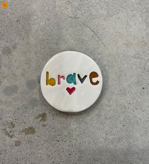 Brave stamped ceramic disc wall hanging.