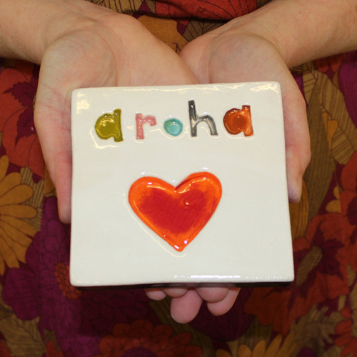 Ceramic aroha stamped wall tile from The Monster Company. Made in NZ.