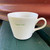 Cream ceramic 350ml capacity mug stamped with 'super dad' in green print.