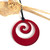 Red tint SoNZ resin koru pendant.