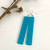 Long rectangle aqua resin earrings with a whale tail design