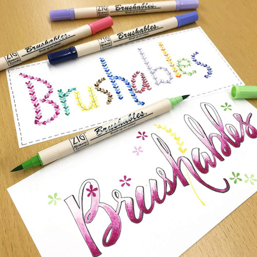 A lifestyle image of Kuretake Zig Brushables Markers in use.