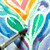 A lifestyle image of a Yasutomo Niji Oil Pastel Set in use for watercolor resist.
