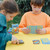 A lifestyle image of an EeBoo Dinosaur Rummy Card Game in use.