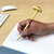 A lifestyle image of a Kikkerland Mushroom Pen in use.
