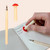 A lifestyle image of a Kikkerland Erasable Mushroom Pen in use.
