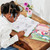 A lifestyle image of an EeBoo Learn To Draw Magical Creatures Art Book in use.