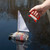 A lifestyle image of a Huckleberry Make-Your-Own Sailboat Kit in use.