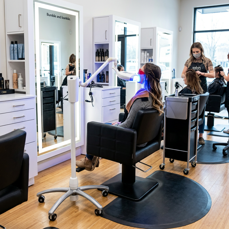 Client receiving a BleachBright LED teeth whitening treatment in a salon chair
