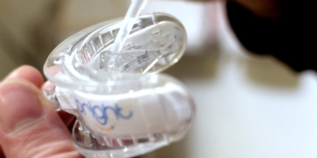 applying whitening gel to the ibright LED mouth tray