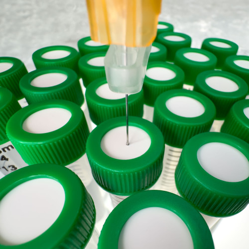 A syringe dispensing a sample into a centrifuge tube through a SeptaSecure uncut silicone septum cap, part of an automated setup designed for precise sample handling. This image highlights the integration of robotics in laboratory sampling processes, ensuring high precision and sample integrity with minimal human intervention.