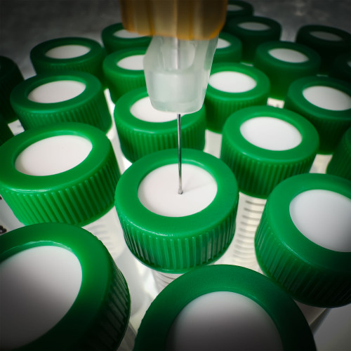 A syringe needle piercing  the uncut septum of a SeptaSecure cap, designed for 15 mL centrifuge tubes. This visual highlights the cap's functional design, allowing for easy sampling without compromising the integrity of the contents within.