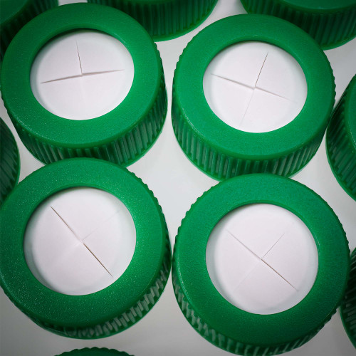 Green SeptaSecure caps with a white cross-cut septum. These caps are designed for 15 mL centrifuge tubes, providing secure and easy access for pipettes and needles. They ensure minimal contamination and maintain sample integrity in laboratory settings.