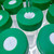 Green 50 mL centrifuge tube caps, each featuring cross-cut SeptaSecure white silicone septa, with a pipette tip precisely dispensing liquid. This setup highlights the SeptaSecure technology designed for easy and contamination-free access, suitable for efficient and accurate laboratory operations.