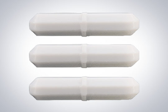 Stack of three white PTFE magnetic stir bars for laboratory mixing.