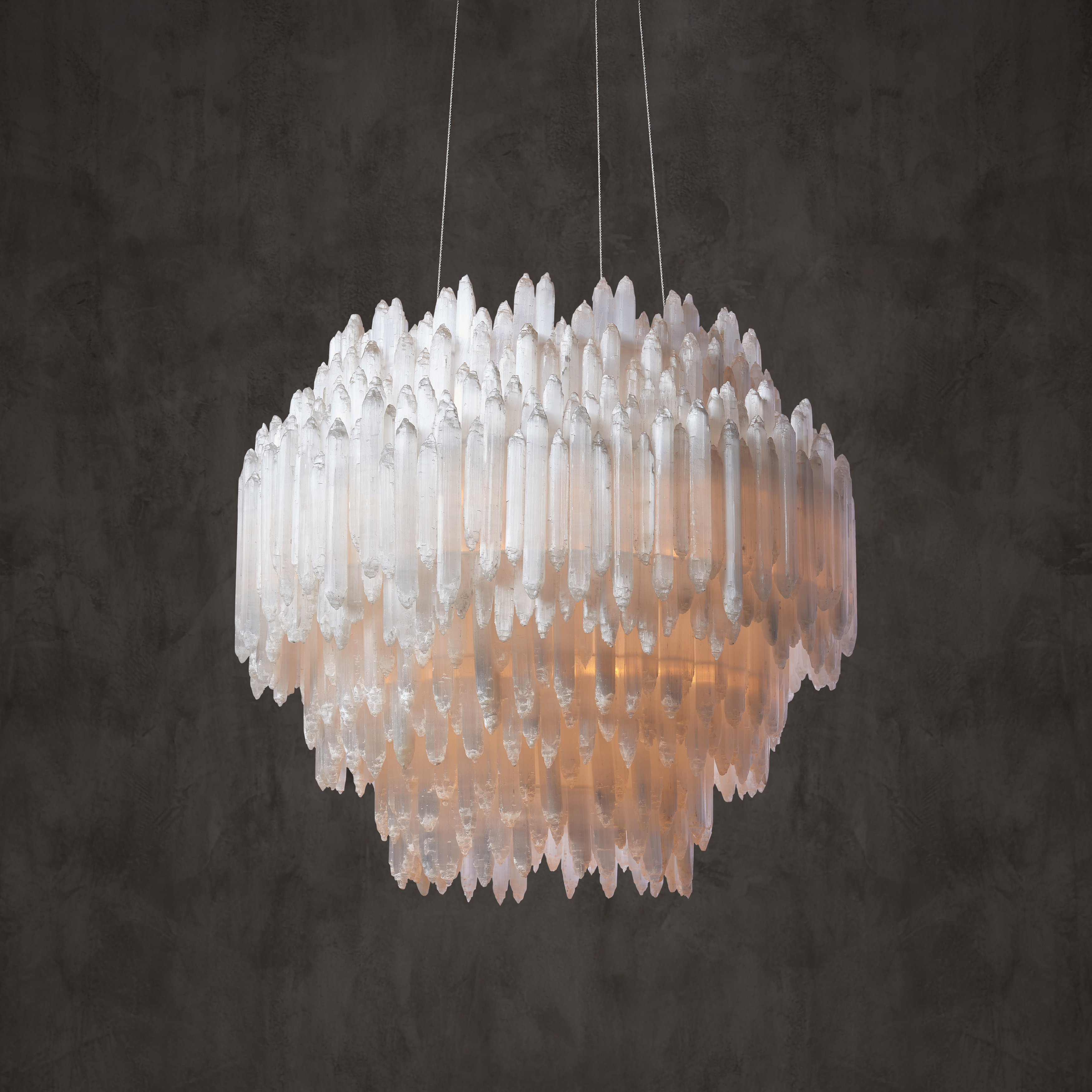 A chandelier with text overlay that reads"Timothy Oulton." "We're not purely a design company per se, it's more than that, it's about the craftsmanship, the materials, the story." - Tim Oulton