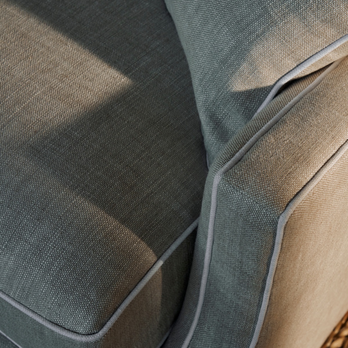 Ashley sofa piping detail in dusty blue linen upholstery.