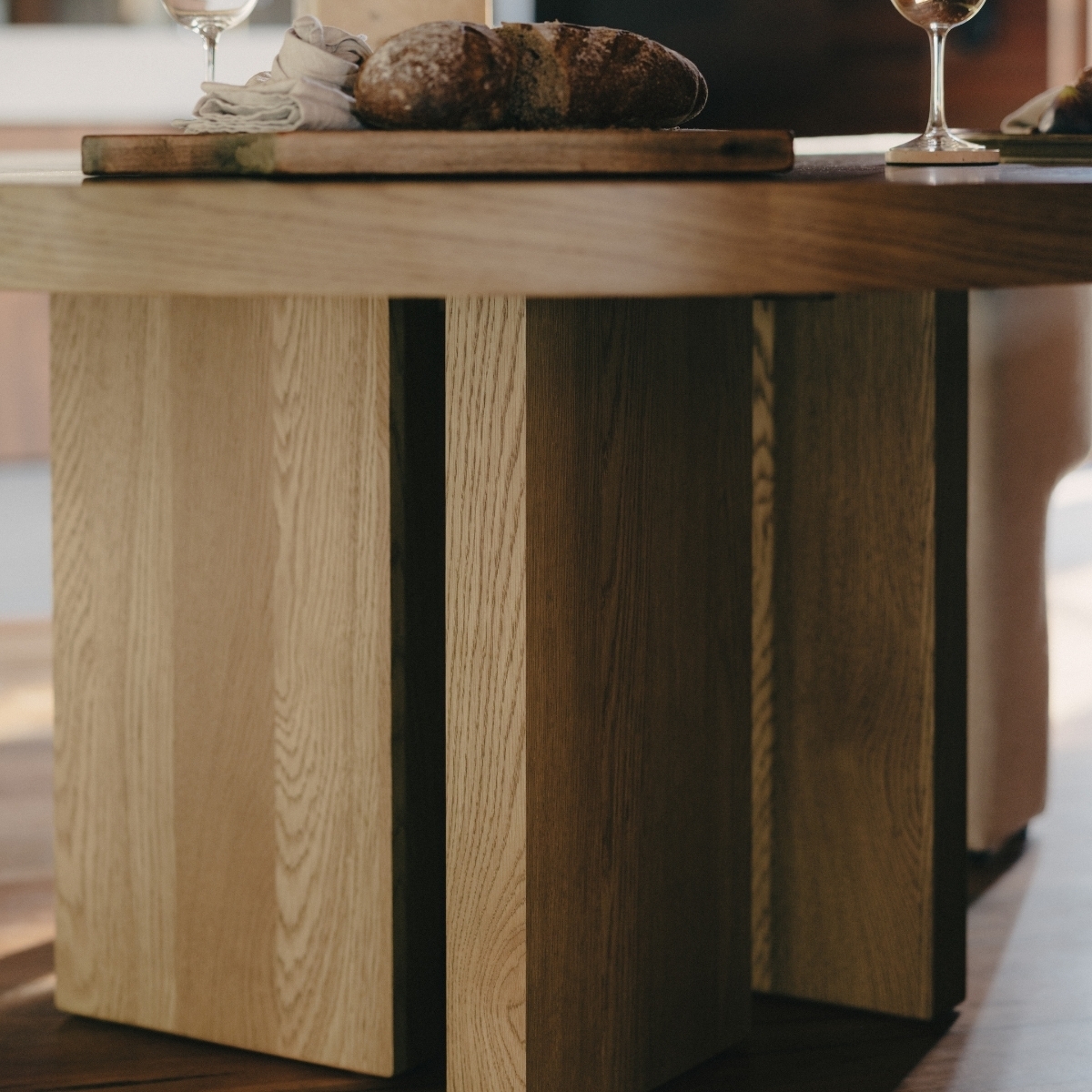 the legs of a light timber dining table