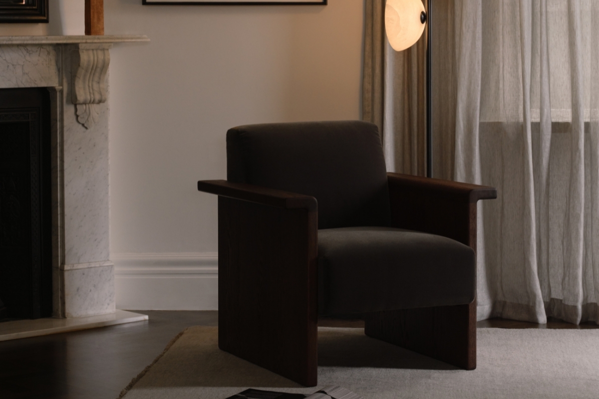 Contemporary reading nook with sculptural black armchair, abstract wall art and soft ambient lighting