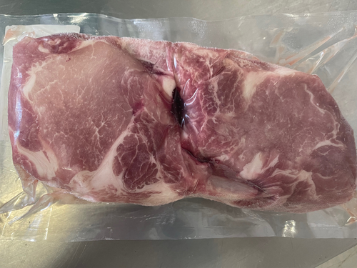 Raw double-thick Duroc Cowboy pork chops, bone-in and individually packaged
