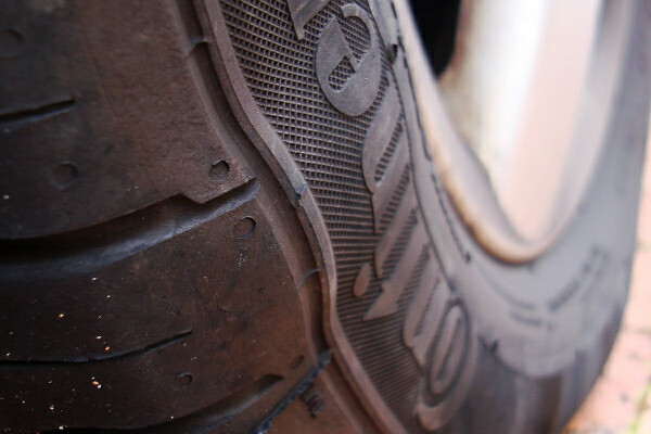 Closeup of a tire sidewall bulge from damage