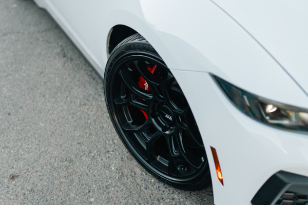 Closeup of a 19 inch low profile tire with an aftermarket wheel