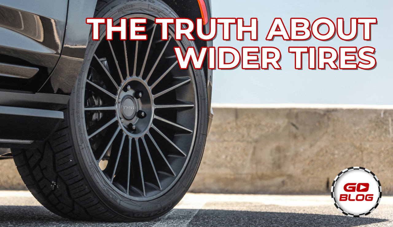 Aftermarket wheels and tires on a vehicle, illustrating wider tire grip and real-world tradeoffs