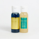 Two clear rounded bottles are pictured on a white background. One bottle contains a dark blue serum and has a gold label that reads "Super CP Serum 1 oz". The other bottle contains a light yellow serum and a teal label that reads "Exfol Serum 1 oz" in gold lettering.