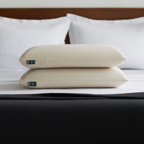 Two pillows stacked on a bed
