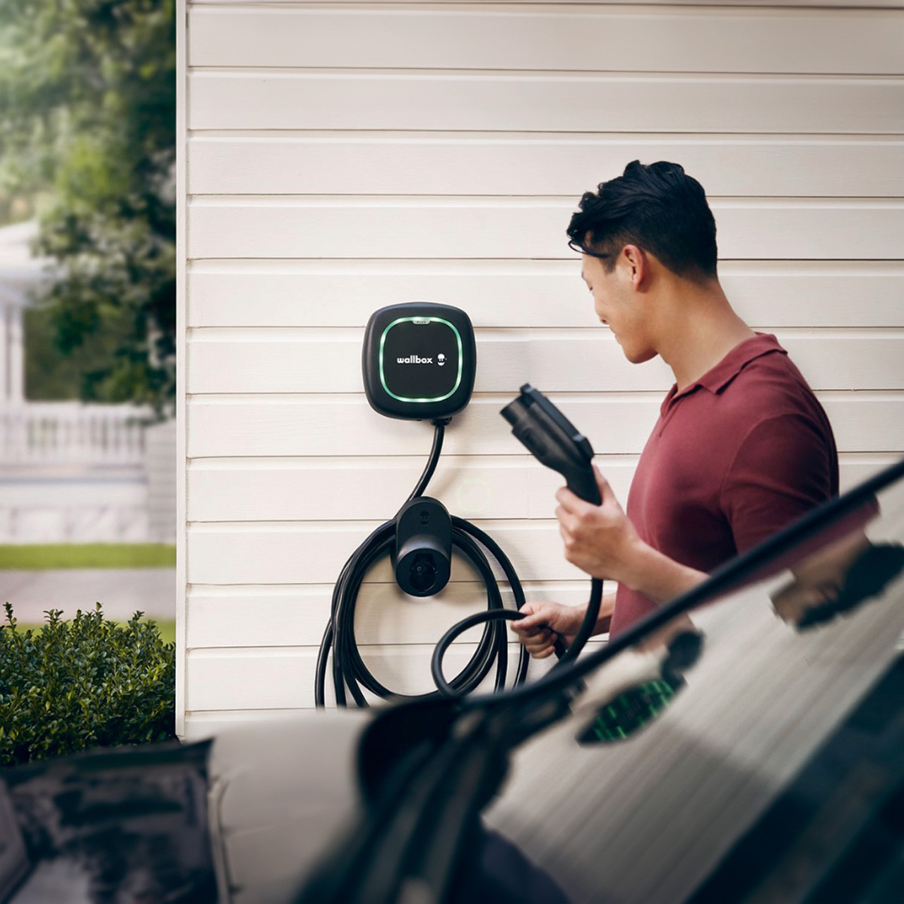 Man charging his car with a Wallbox Pulsar Plus Charger