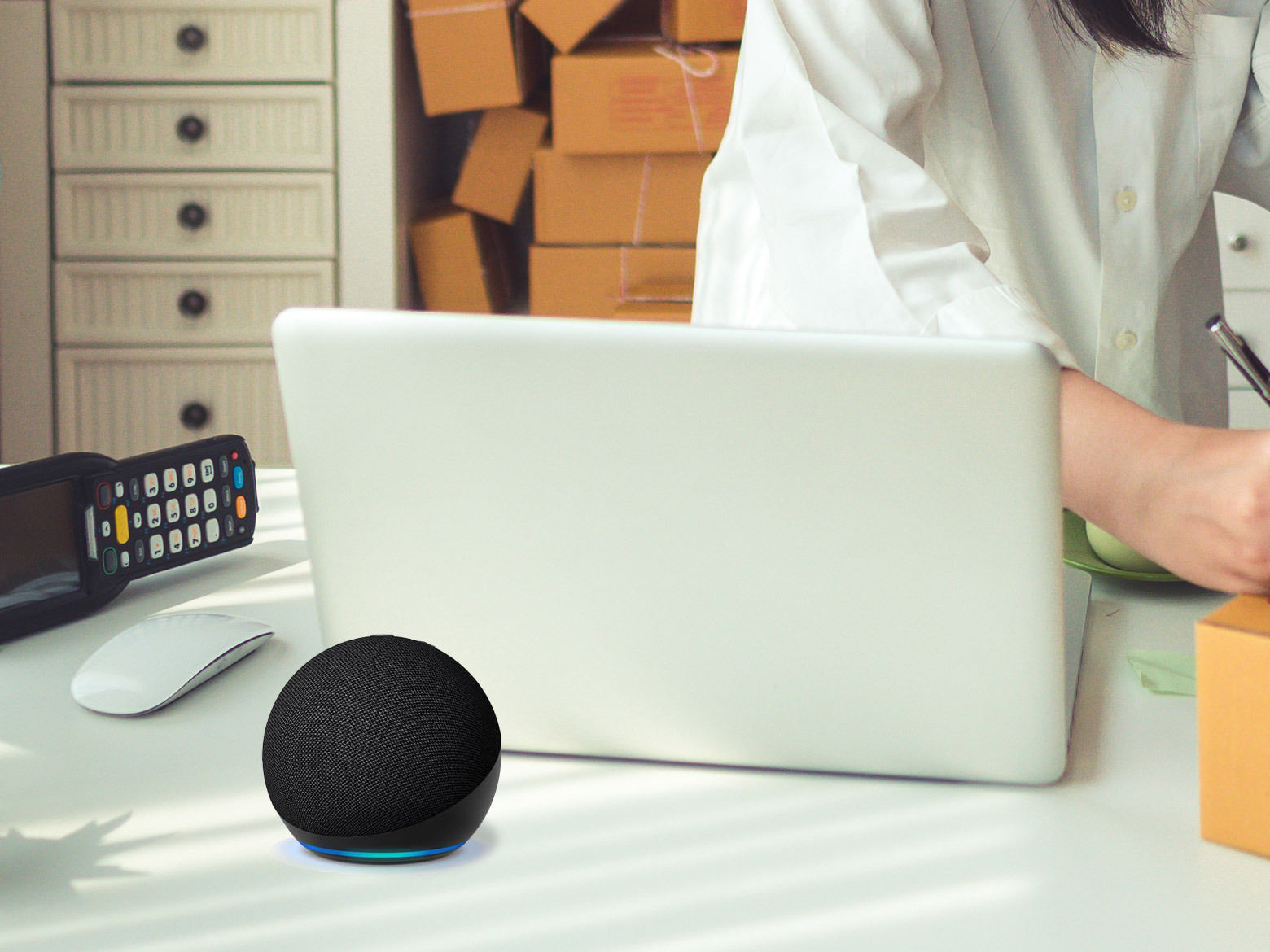 Echo dot on the office desk with laptop in the background