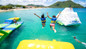 Resort day pass kids jumping in the ocean at Splash Island Water Park at Bay Gardens Beach Resort in St. Lucia. 
