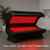Full-body red light therapy bed with open clamshell design and illuminated red LED panels in a modern wellness room