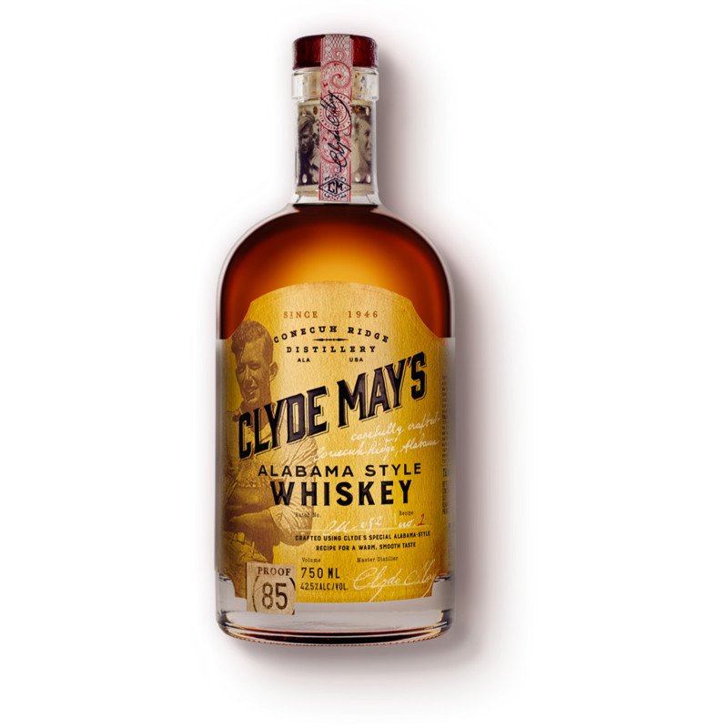 Clye May's Whiskey, available since 1946, legal since 2001. In 1946, before there was a craft whiskey boom, Clyde May, the legendary moonshiner, revolutionized the art of whiskey making by crafting a unique style of whiskey we refer to as Alabama Style. Clyde discovered that by using dried apples in the aging process, it resulted in a whiskey of unparalleled smoothness and richness. The ultimate sipping whiskey. Today we honor his legacy with a blend of 4 year old bourbon distilled and aged in oak barrels, finished with a hint of natural apple essence. Its not a flavored whiskey, but a whiskey with flavor. Attention to detail and commitment to quality, then, and now. He’d be so proud. Distilled since 1946, legal since 2001 Award winning package design and liquid Official State Spirt of Alabama Say Whatcha Be an Be Whatcha Say