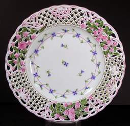 Herend Blue Garland Pierced Plate featuring delicate floral garlands, hand-painted blossoms, and an ornate reticulated rim. A collectible and retired piece of fine porcelain.