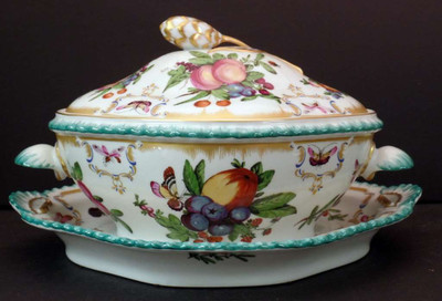 Mottahedeh Duke of Gloucester Tureen and Lid with Underplate features hand-painted motifs and gold accents, 9 3/8" x 7 1/8".