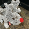 Small grey brushwood reindeer with scarf, red nose & plant area