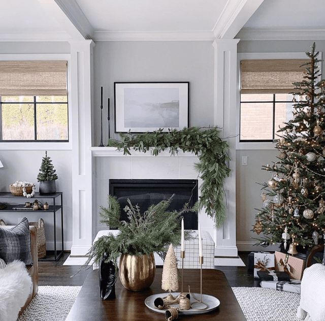 Christmas living room with mantel greenery, tree styling, and holiday decorating layers