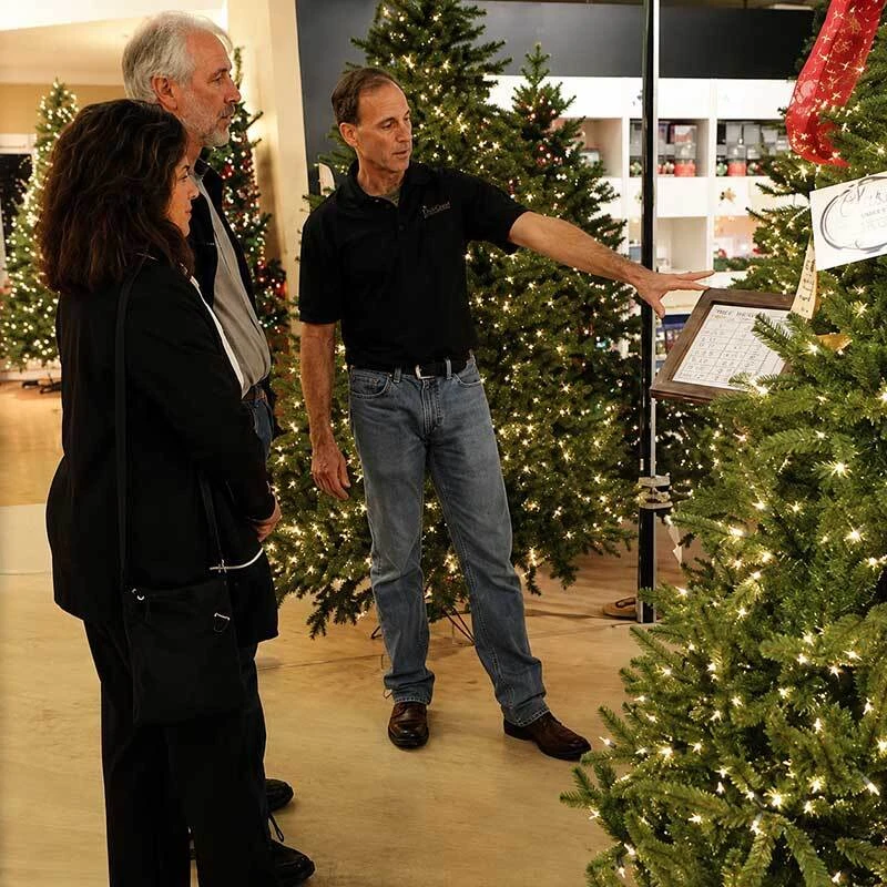 Treetime team helping customers choose artificial Christmas trees