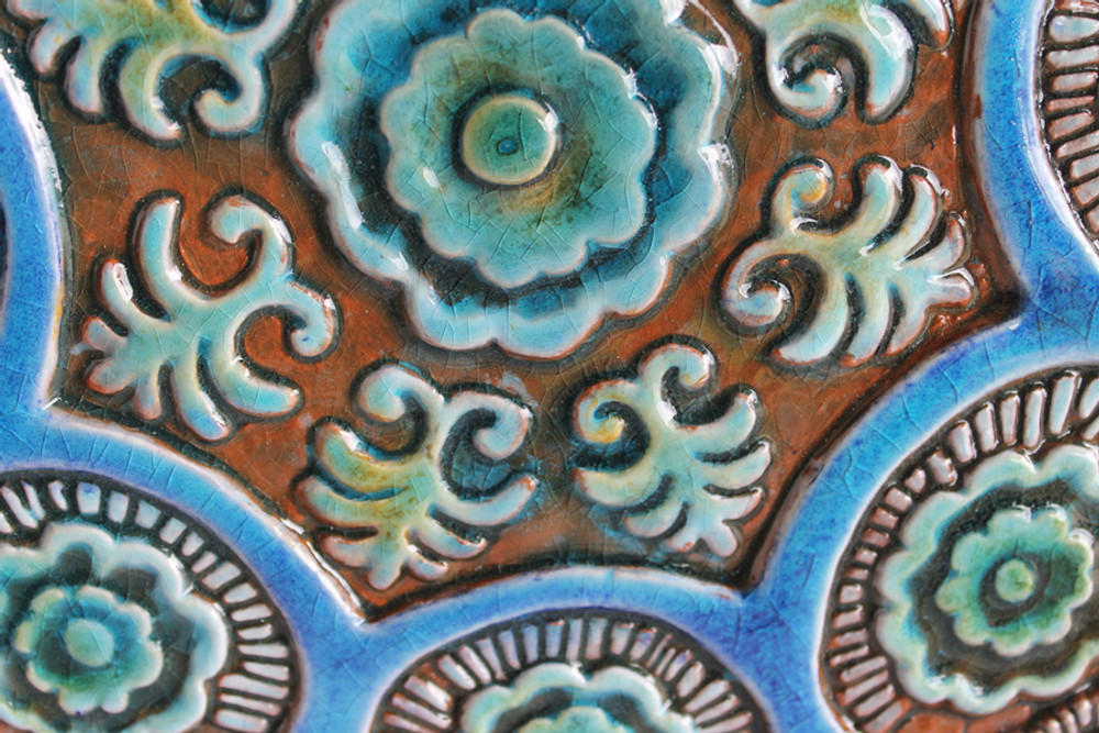 These handmade tiles are glazed in turquoise and make unique wall hangings for kitchens and bathrooms. Our decorative tiles also make wonderful outdoor wall art.  Circle garden decor handmade in Spain.