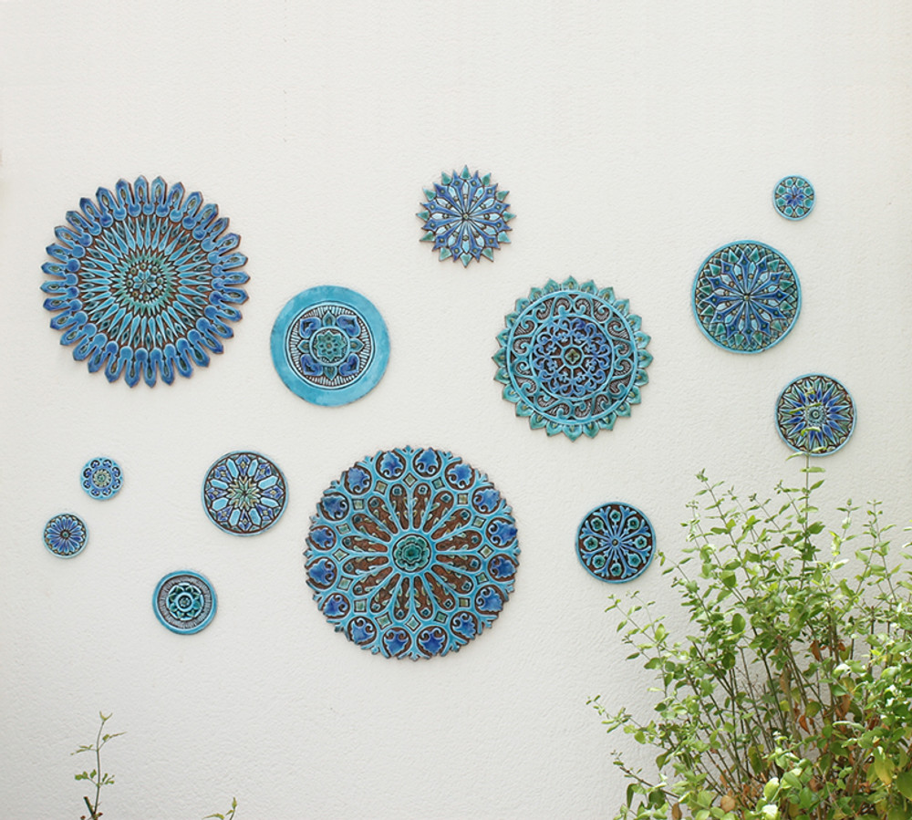 These circular tiles make beautiful outdoor wall art and unique wall hangings for kitchens and bathrooms. Our decorative tiles can also be combined with our other handmade tiles to make larger wall art installations.