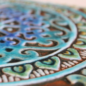 Turquoise handmade tile with decorative relief. Decorative tile handmade in Spain.